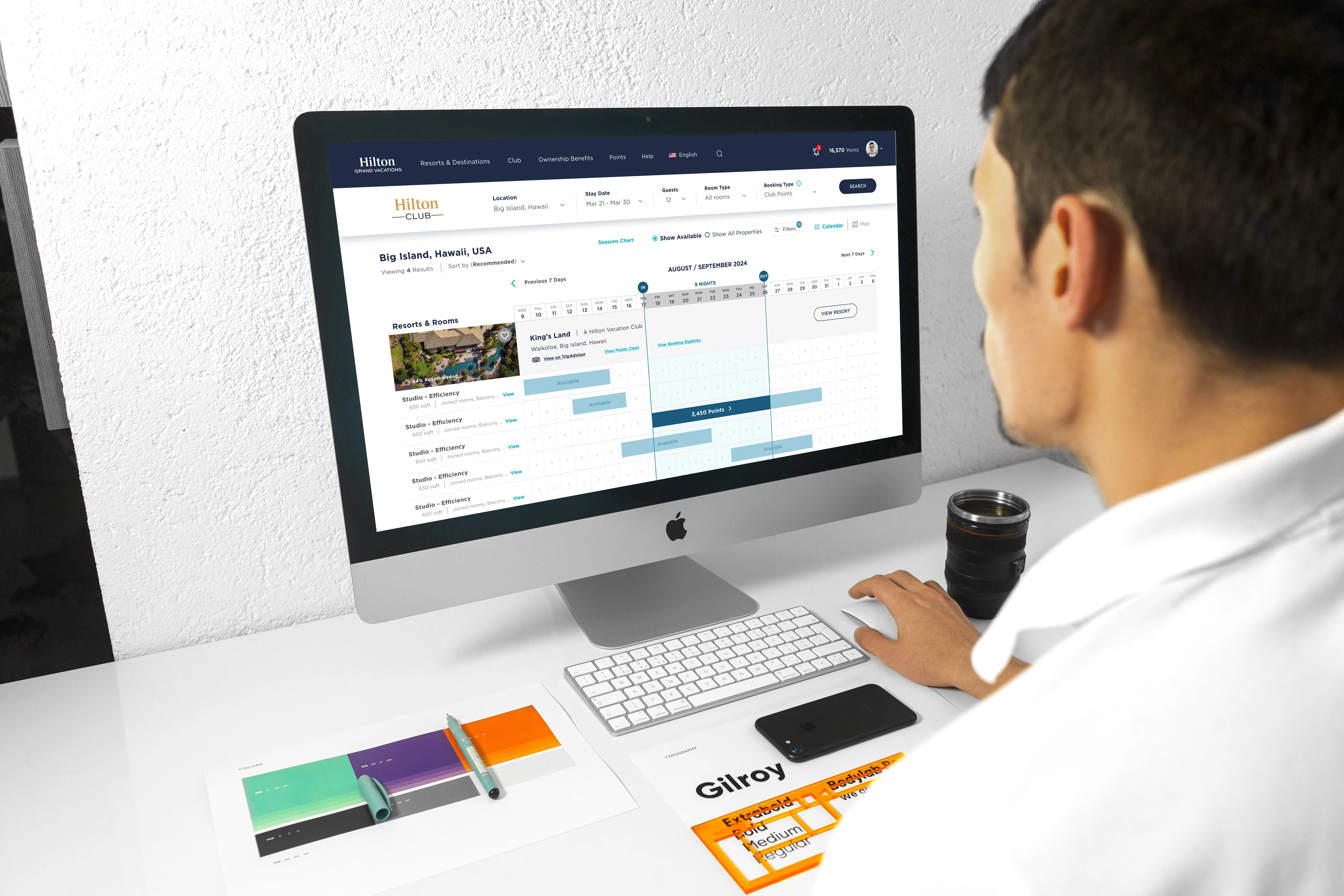Booking experience shown on iMac in a bright office environment